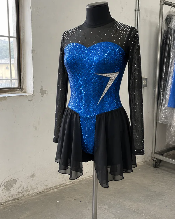 The ENCORE costume on a dress form: a blue sequin bodice with a bolt in clear stones, sheer black sleeves scattered with stones and a black skirt