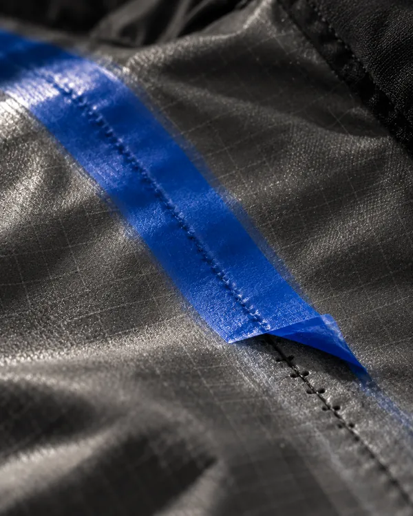 Blue seam tape on the inside of a shell jacket