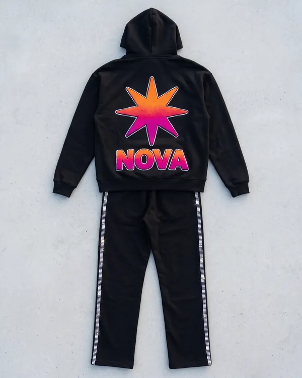 NOVA black fleece hoodie and track pants laid flat, with a chenille starburst on the hoodie and rhinestone rails down each leg