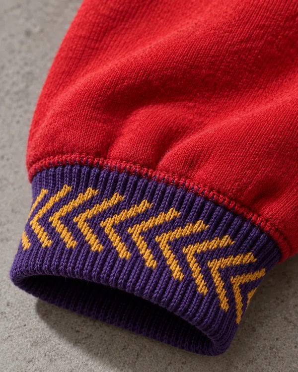 Gold and purple jacquard rib cuff on a red hoodie