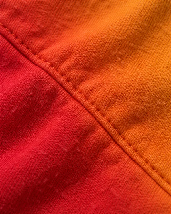 Orange to red sublimated fleece running across a seam