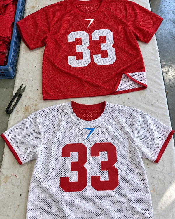 A reversible mesh practice jersey shown on both sides: scarlet with a white 33, and white with a red 33