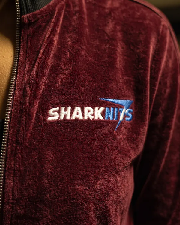 SHARKNITS logo embroidered on burgundy velour