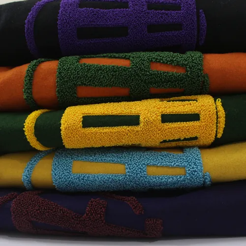 Five chenille crests stacked