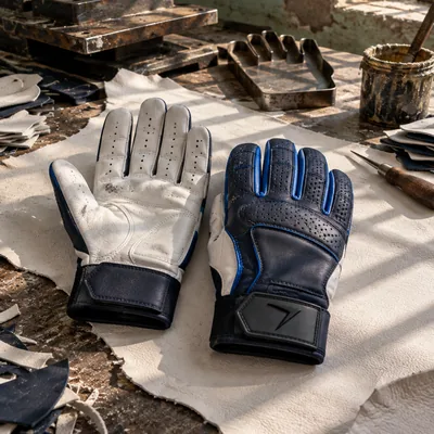 Baseball batting gloves: a white leather palm and a navy back with blue piping