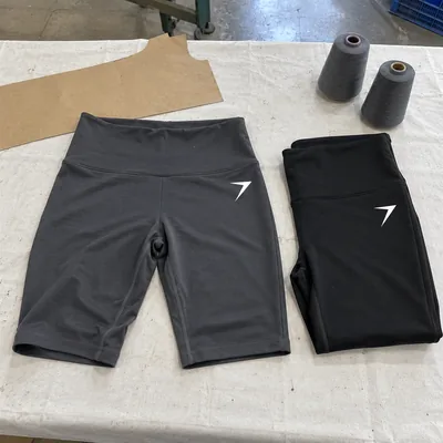 Charcoal and black high-rise biker shorts with a white bolt on the hip
