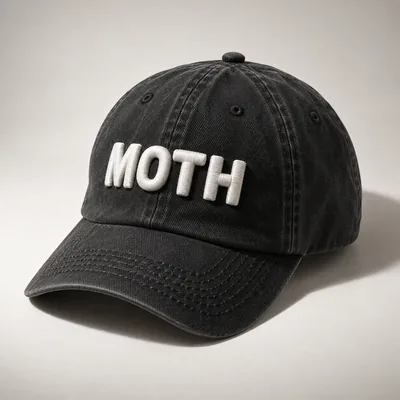 Washed black dad cap with MOTH in raised white embroidery