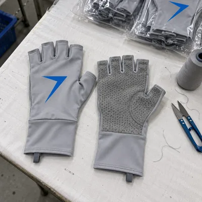 Light gray fingerless fishing gloves, one showing a blue bolt on the back and one a palm with grip dots