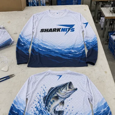 White and blue TIDE fishing jersey, front and back, with SHARKNITS across the chest and a leaping bass on the back