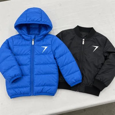 A blue kids puffer jacket with a plain hood edge beside a black kids bomber jacket