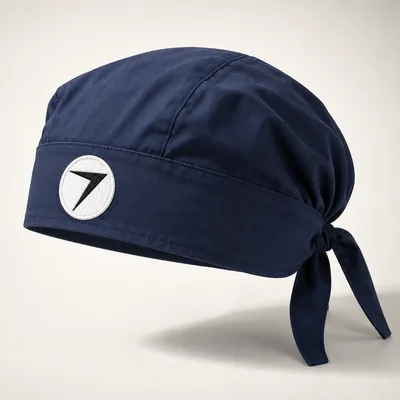 Navy tie-back scrub cap with a round bolt patch on the band