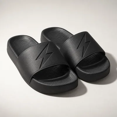 Black slides with a debossed bolt on the strap