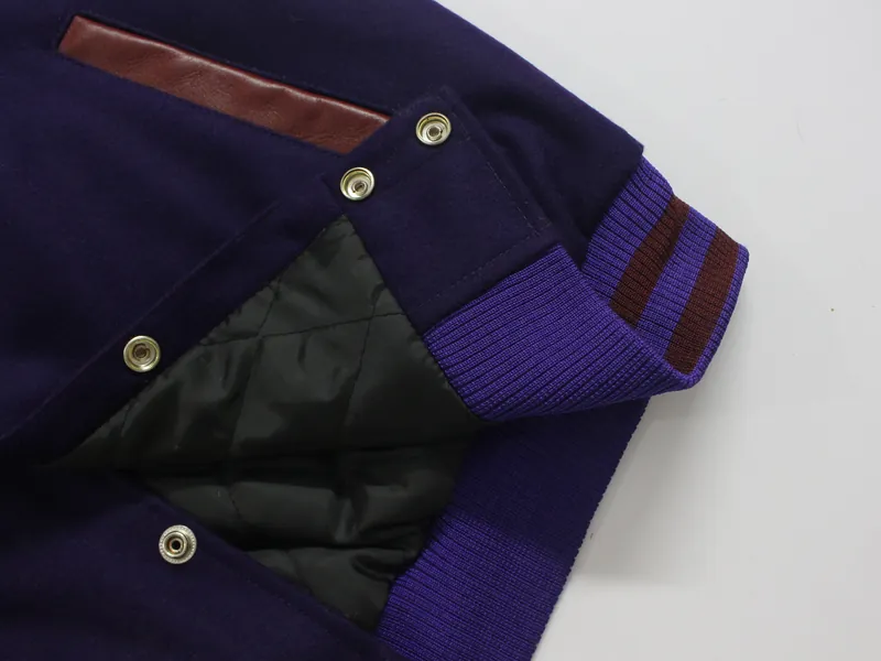 Inside a purple varsity jacket: quilted lining, snaps and striped rib cuff