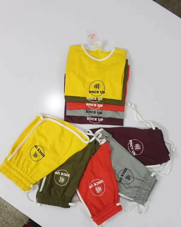 Stacks of finished Fince Up tees and shorts