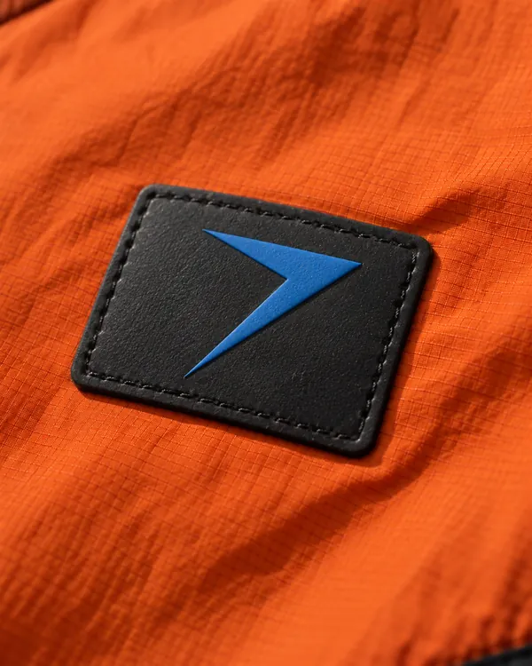 Black rubber patch on orange nylon