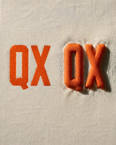 Raised orange puff print letters on cream fleece